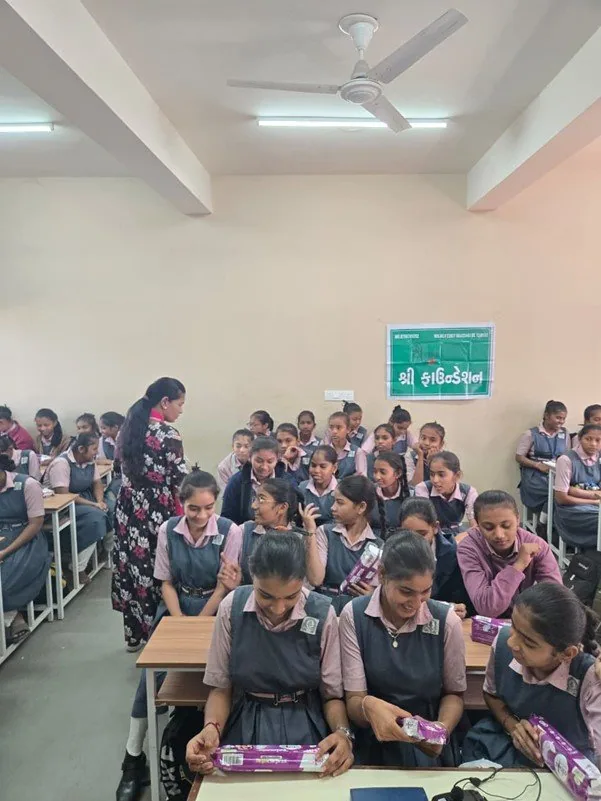 Schoolgirls receiving sanitary pads during a Shree Foundation menstrual hygiene session