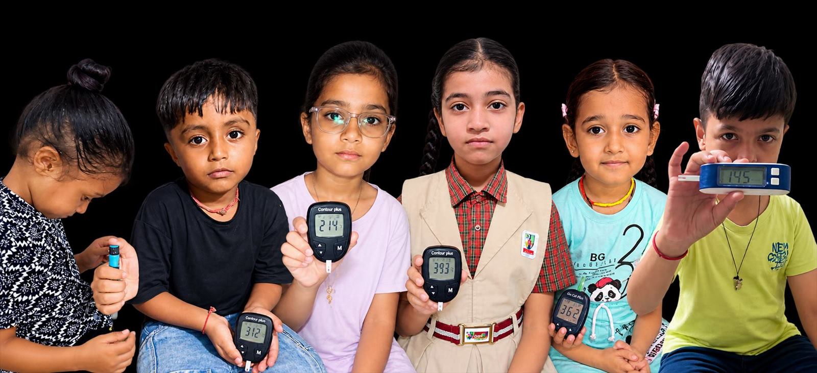 Children supported by Project MadhuKishor holding blood glucose meters